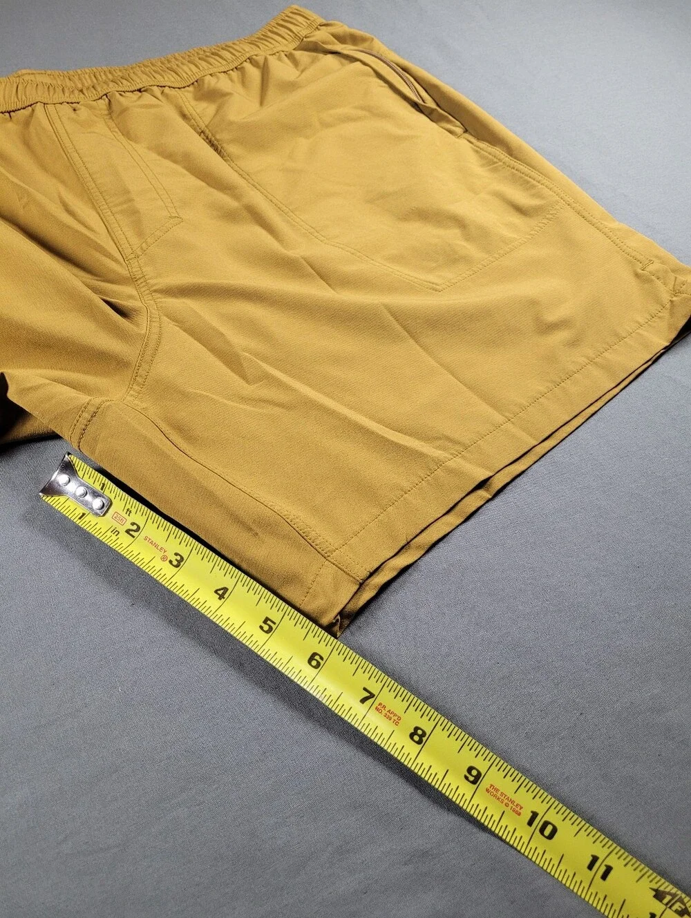 Janji Running Trail Shorts XL Golden Tan Zip Pockets Stretch Activewear